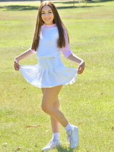 Brunette cutie Kelly reveals her tiny tits and fingers her snatch in the park